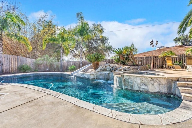 view of swimming pool with an in ground hot tub and a patio