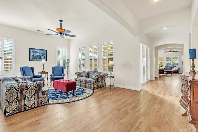 living room with ceiling fan and light hardwood / wood-style flooring