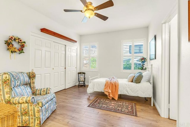 bedroom with hardwood / wood-style flooring, ceiling fan, and a closet