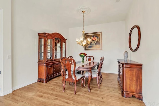 dining area featuring an inviting chandelier and light wood-type flooring