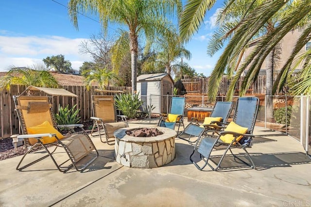 view of patio featuring an outdoor fire pit and a storage unit