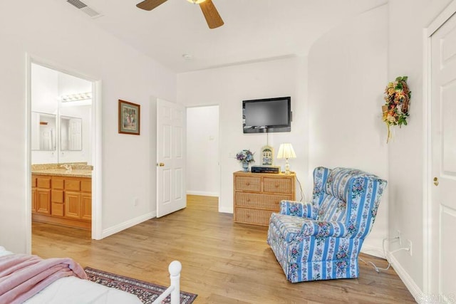 sitting room with ceiling fan and light wood-type flooring