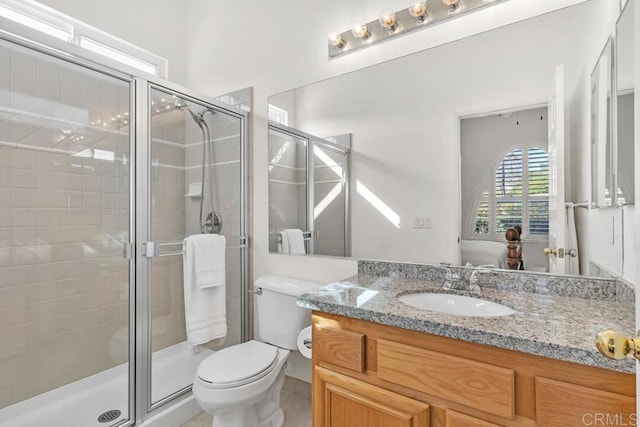 bathroom with vanity, toilet, and an enclosed shower