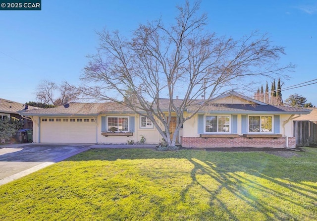 ranch-style home featuring a garage and a front lawn