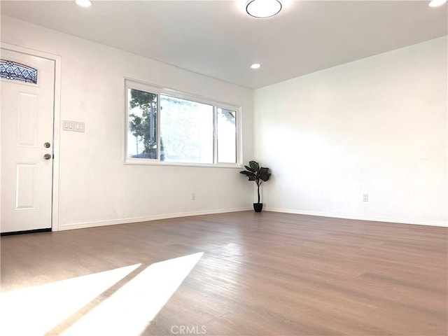 unfurnished room with wood-type flooring