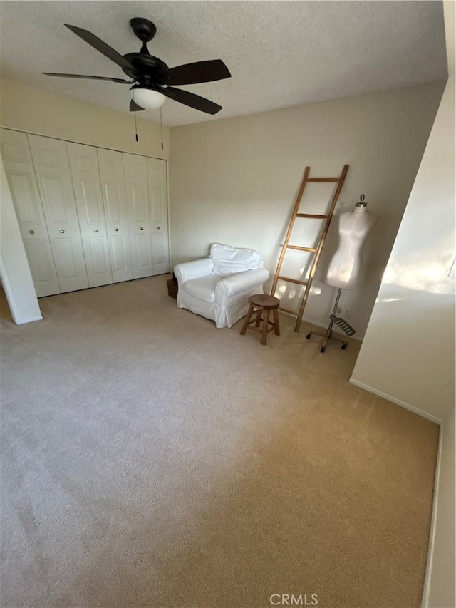 unfurnished room featuring ceiling fan and carpet