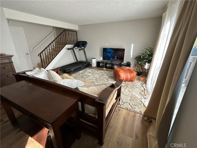 living room featuring a textured ceiling and light hardwood / wood-style flooring