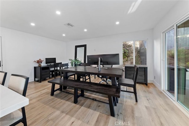 dining space featuring light wood-type flooring