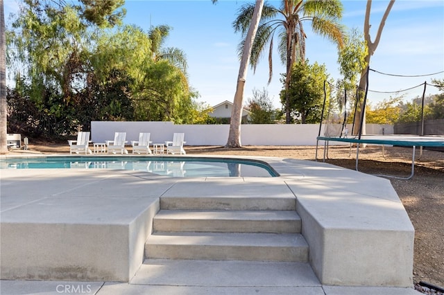 view of swimming pool featuring a trampoline