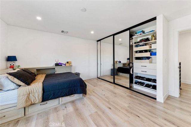 bedroom featuring light hardwood / wood-style floors and a closet