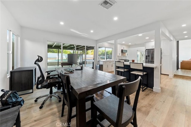 dining room featuring light hardwood / wood-style floors and sink