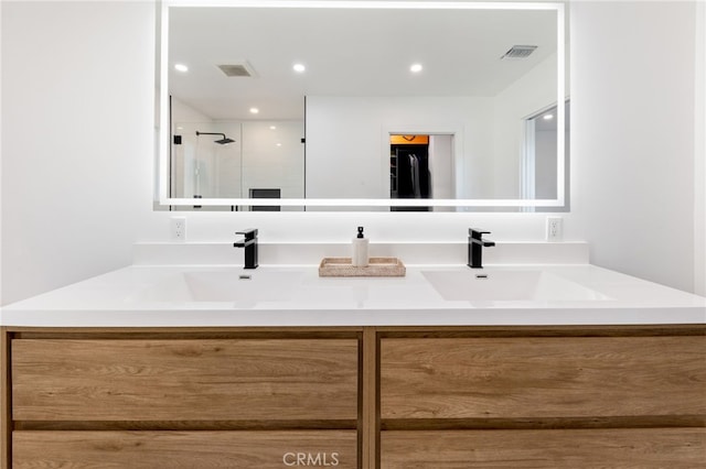 bathroom featuring an enclosed shower and vanity