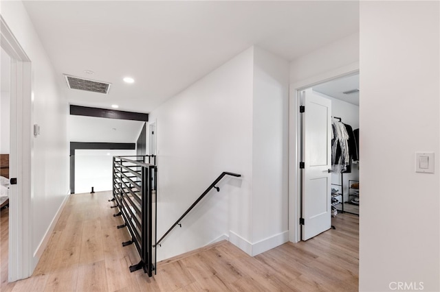 corridor with light hardwood / wood-style floors