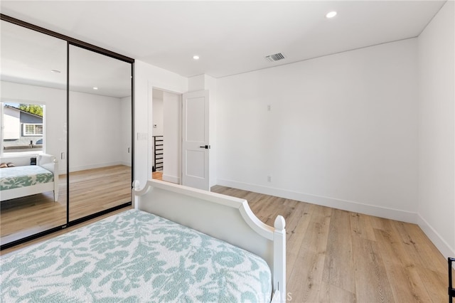 bedroom featuring a closet and light hardwood / wood-style flooring