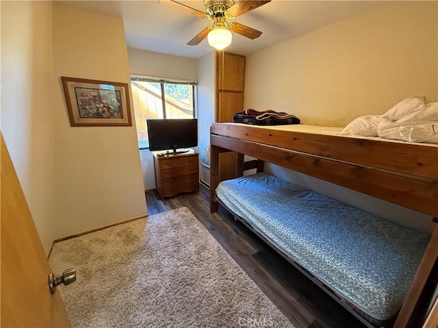 bedroom featuring ceiling fan and dark hardwood / wood-style flooring