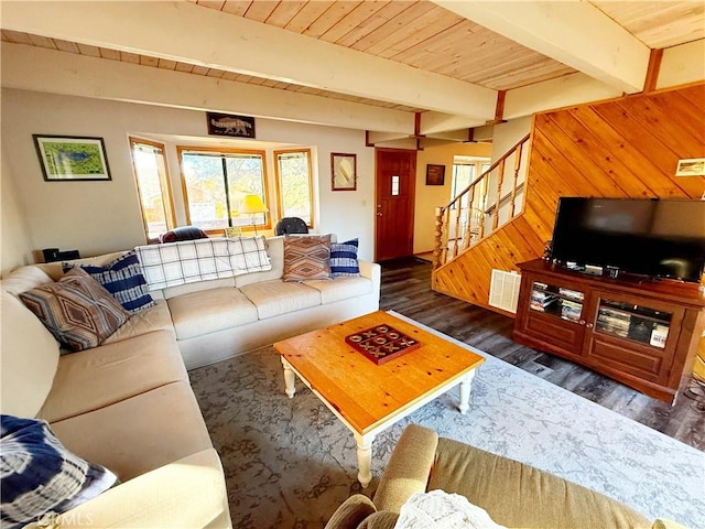 living room with dark wood-type flooring, wooden walls, beam ceiling, and wood ceiling