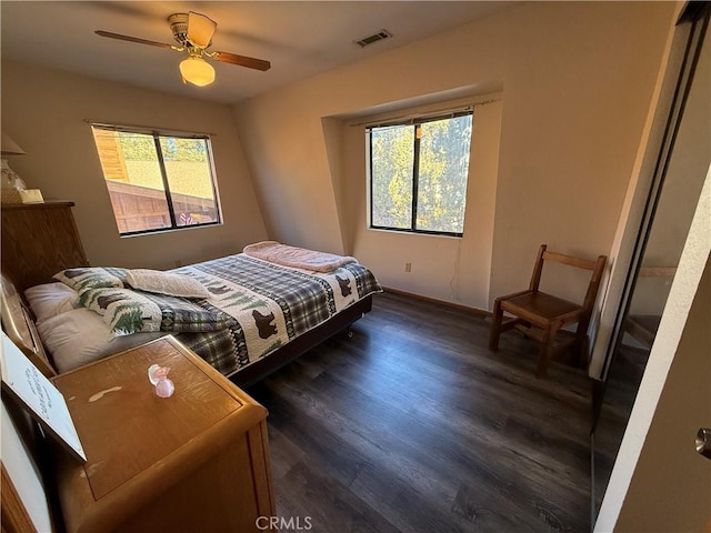 bedroom with ceiling fan and dark hardwood / wood-style floors