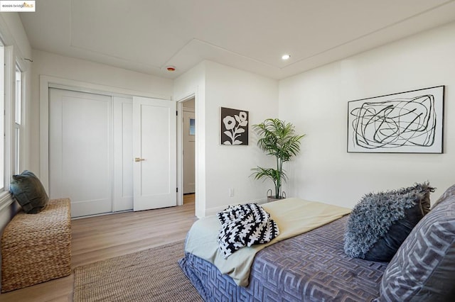 bedroom with hardwood / wood-style flooring and a closet