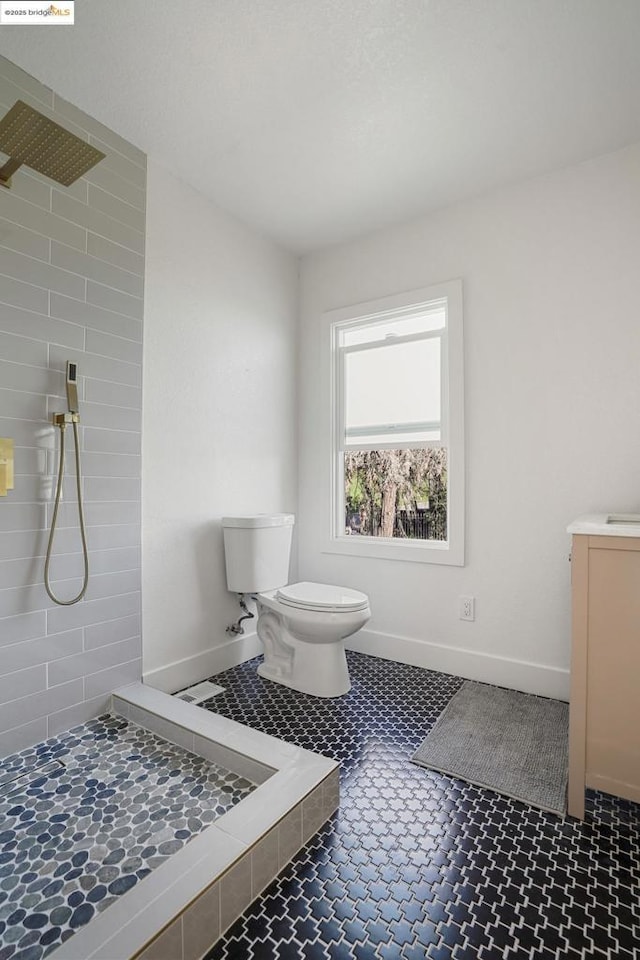 bathroom featuring a shower and toilet