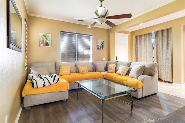 living room featuring hardwood / wood-style flooring, ornamental molding, and ceiling fan