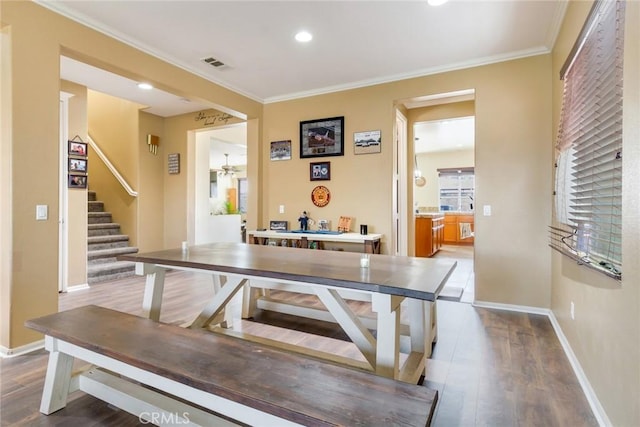 game room featuring ornamental molding and dark hardwood / wood-style flooring