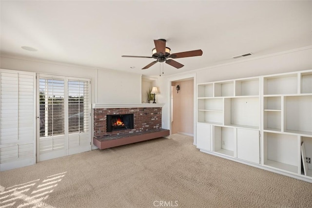 unfurnished living room with ceiling fan, carpet, and a fireplace