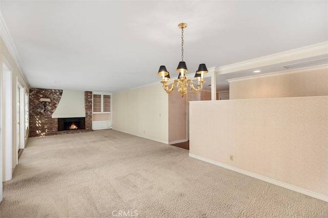 unfurnished living room with a brick fireplace, crown molding, carpet floors, and a chandelier