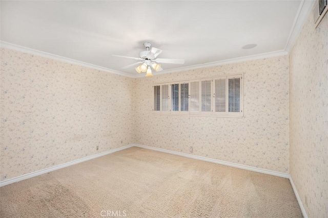 carpeted spare room featuring ornamental molding and ceiling fan