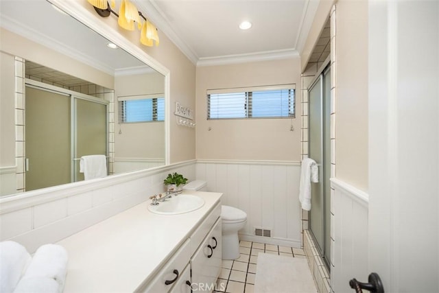 full bathroom featuring toilet, combined bath / shower with glass door, crown molding, vanity, and tile patterned flooring