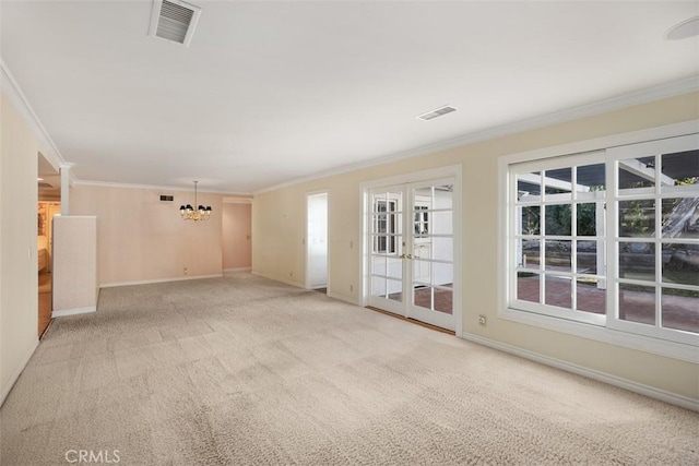 unfurnished room with an inviting chandelier, ornamental molding, and light carpet