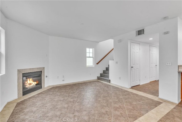 8856 Burnet Ave, North Hills, CA 91343 - unfurnished living room with tile patterned flooring, stairs, a tile fireplace, and recessed lighting