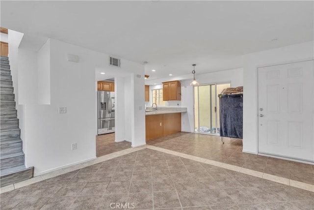 8856 Burnet Ave, North Hills, CA 91343 - unfurnished living room featuring light tile patterned floors, stairs, and recessed lighting