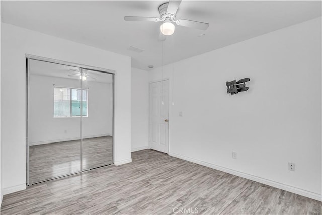 8856 Burnet Ave, North Hills, CA 91343 - unfurnished bedroom with wood finished floors, a closet, and a ceiling fan