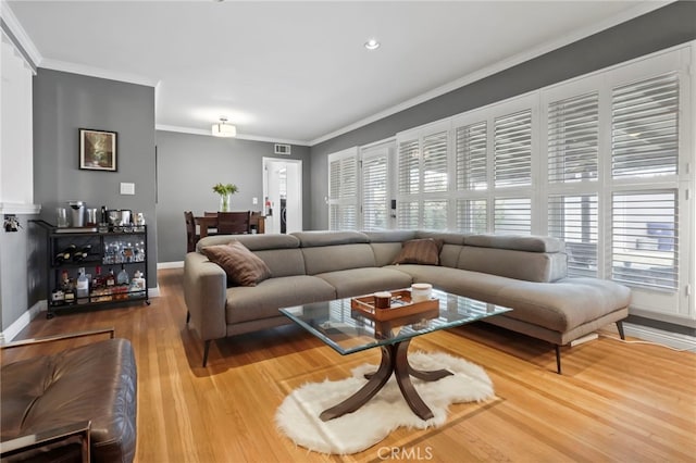 living room featuring hardwood / wood-style flooring and ornamental molding