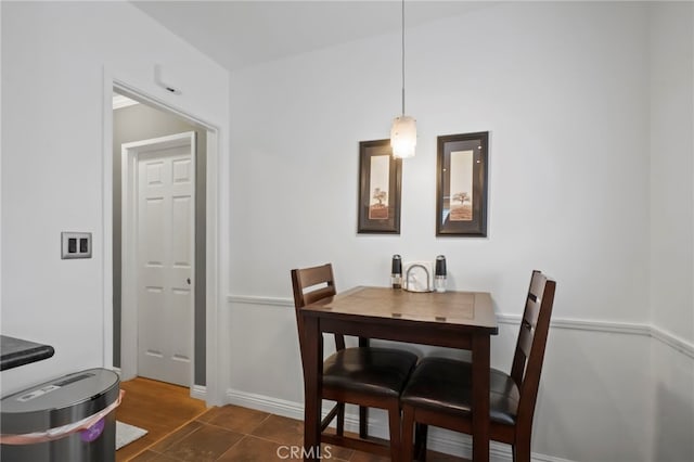 dining area featuring dark tile patterned flooring