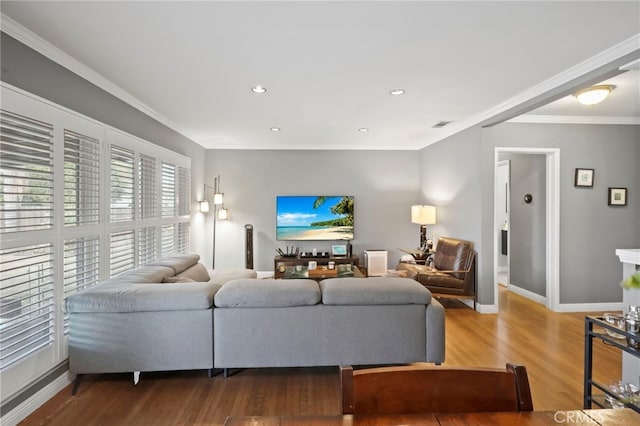 living room featuring hardwood / wood-style flooring and crown molding