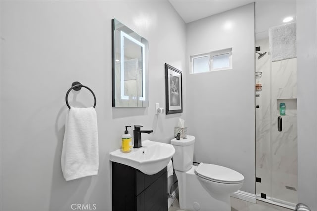 bathroom with vanity, an enclosed shower, and toilet