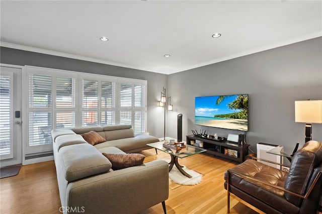 living room with hardwood / wood-style flooring and crown molding