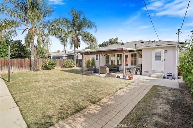 back of property featuring an outdoor living space, a patio area, and a lawn