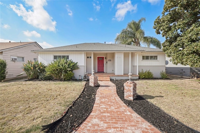 ranch-style house with a porch and a front lawn