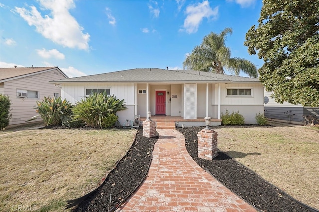 single story home featuring a front lawn and a porch