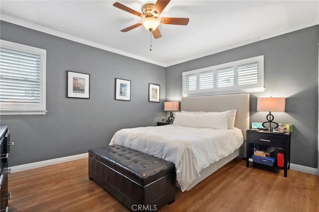 bedroom with ornamental molding, hardwood / wood-style floors, and ceiling fan