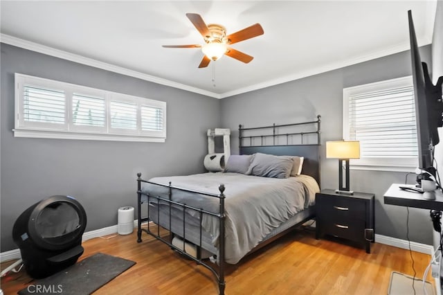 bedroom with crown molding, ceiling fan, and light hardwood / wood-style floors