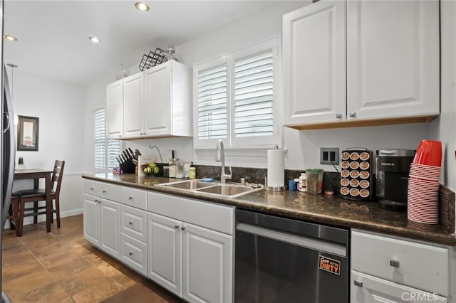 kitchen featuring dishwasher, sink, and white cabinets