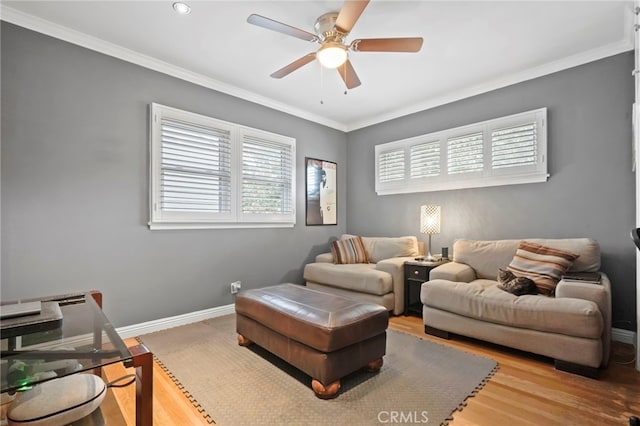 living room featuring hardwood / wood-style floors, ornamental molding, and ceiling fan