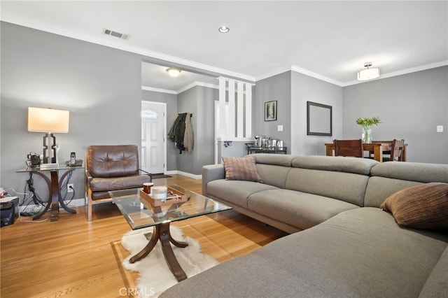 living room featuring hardwood / wood-style flooring and ornamental molding