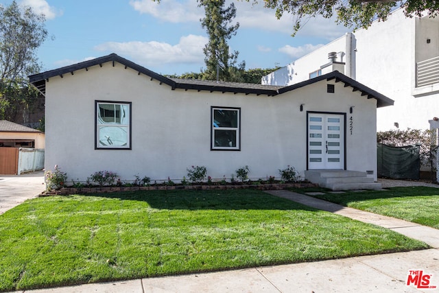 mediterranean / spanish house featuring a front yard