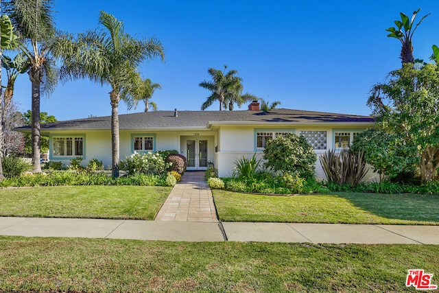 single story home featuring a front lawn and french doors