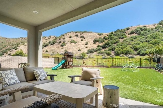 view of patio / terrace with a playground and an outdoor living space