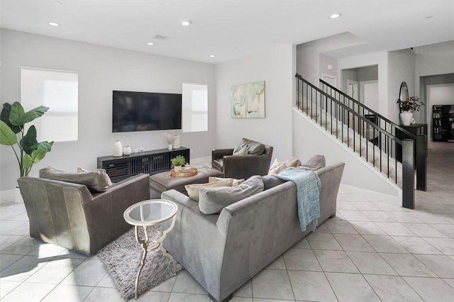 living room featuring a wealth of natural light and light tile patterned floors